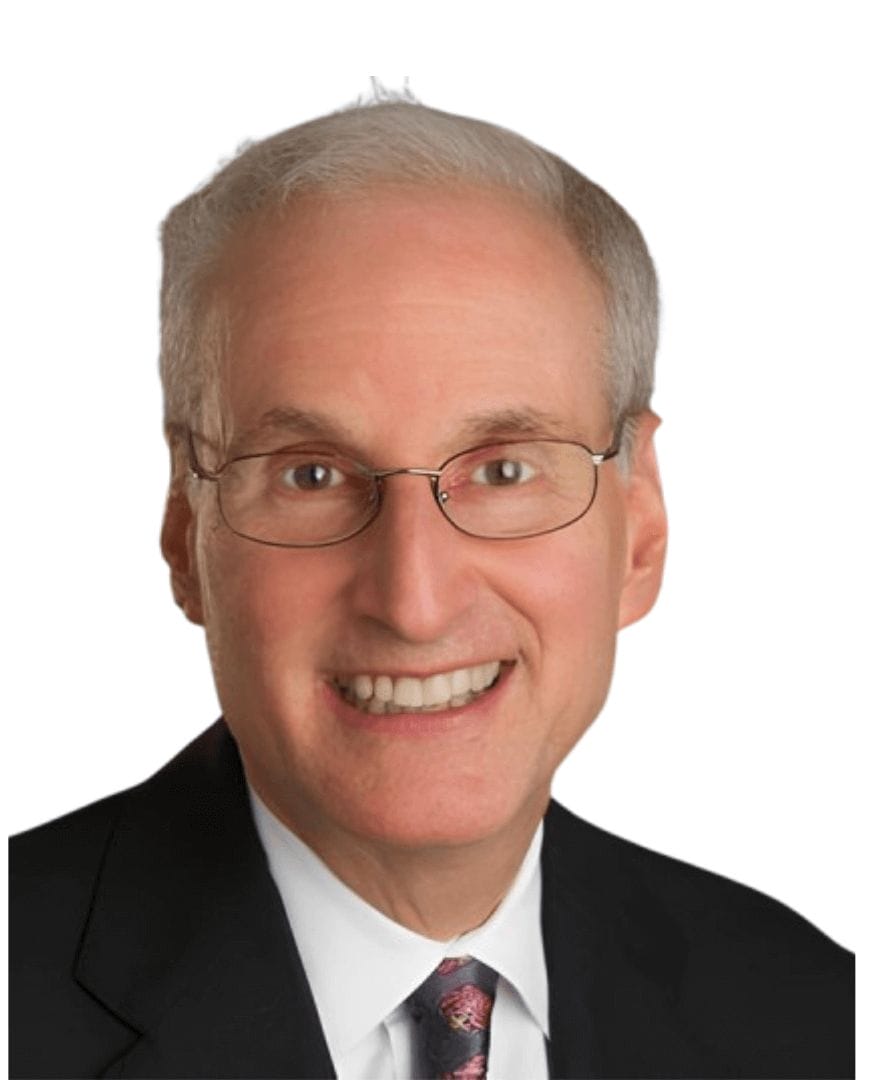 Professional individual smiling, wearing glasses and a suit, featured at Scale Community Events for networking and growth opportunities.